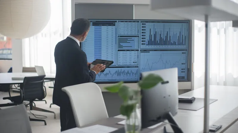 Data analyst reviewing AI pilot accuracy and cost charts on screen